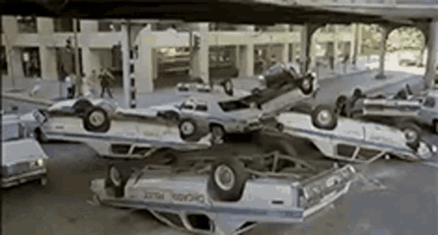 GIf of scene from the movie The Blues Brothers during the police chase in Chicago when dozens of police cars end up crashing and piling up on one another.
