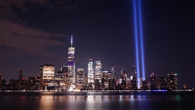 new york skyline at night after the towers fell, with massive lights turned on where the towers had been as a reminder and memorial after the attacks