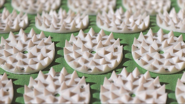 close up of the round disks on an acupressure mat, the kind that is a foam cushion underneath, white spikes coming up for acupressure therapy.