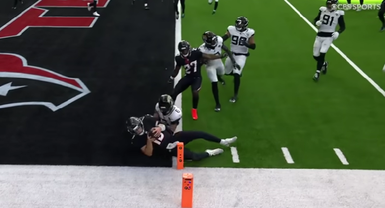 still taken from CBS Sports of the Texans vs. Jaguars week 10 game, Nov 9th, 2025. Shows Texans QB, Mills, mid-dive into the end zone right next to the orange pylons marking TD territory, a move that put the Texans ahead in the last minute of the game.